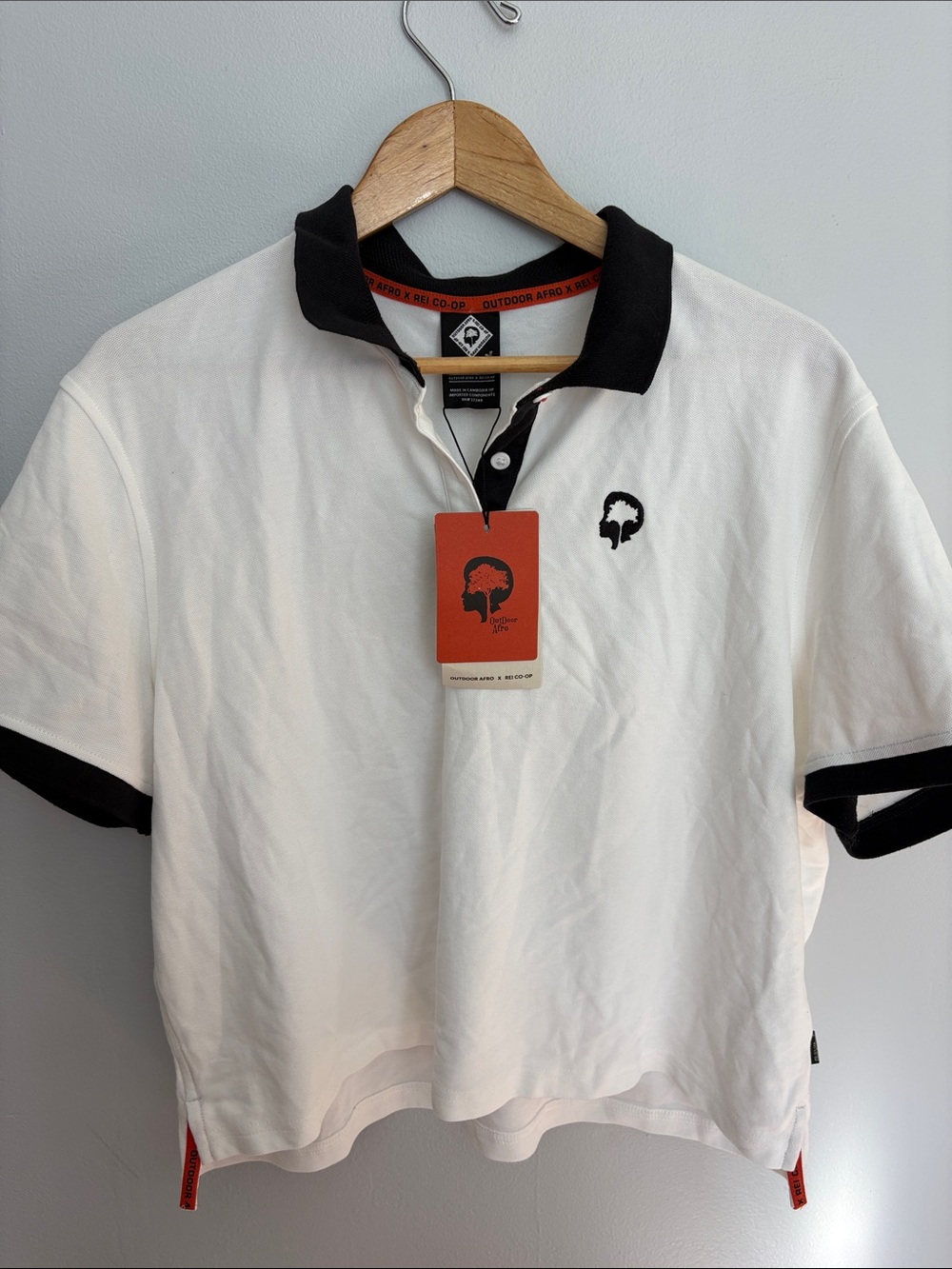REI White Polo Shirt with Black Trim